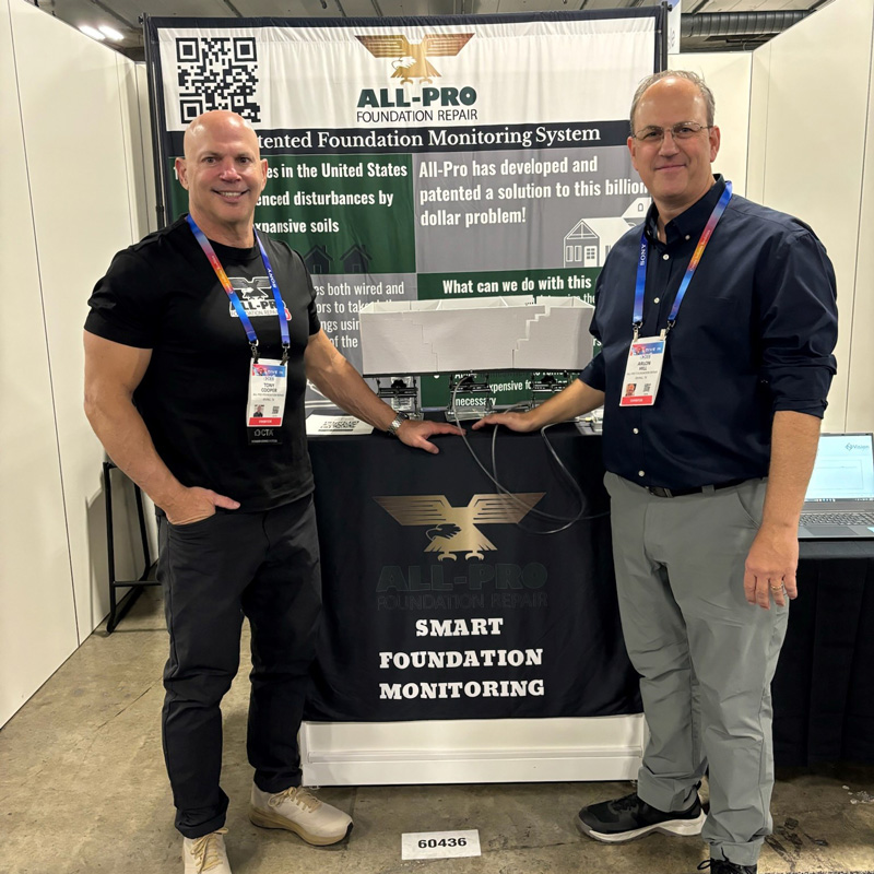 two men at a booth at a trade show